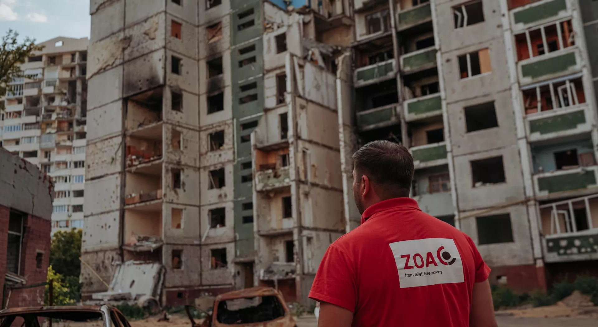 ZOA employee looking at broken buildings