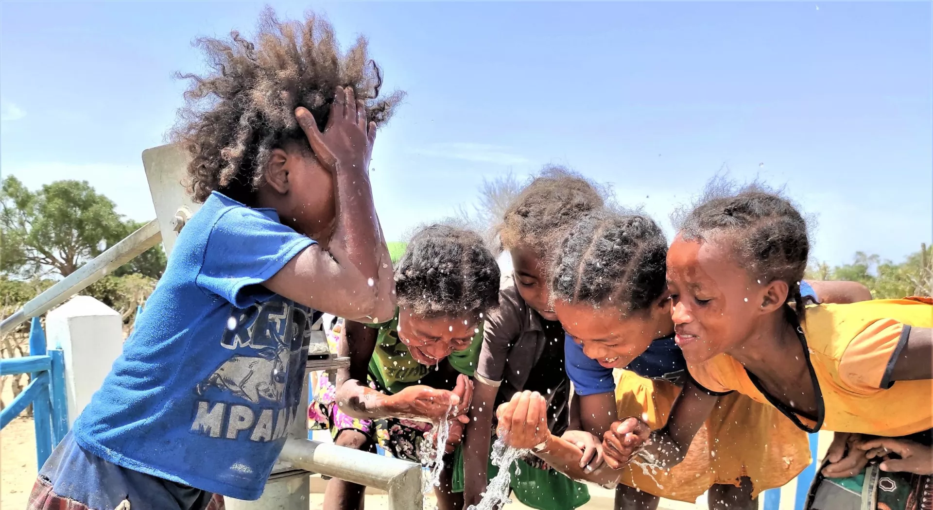 Children enjoy water at a waterstation built by Medair