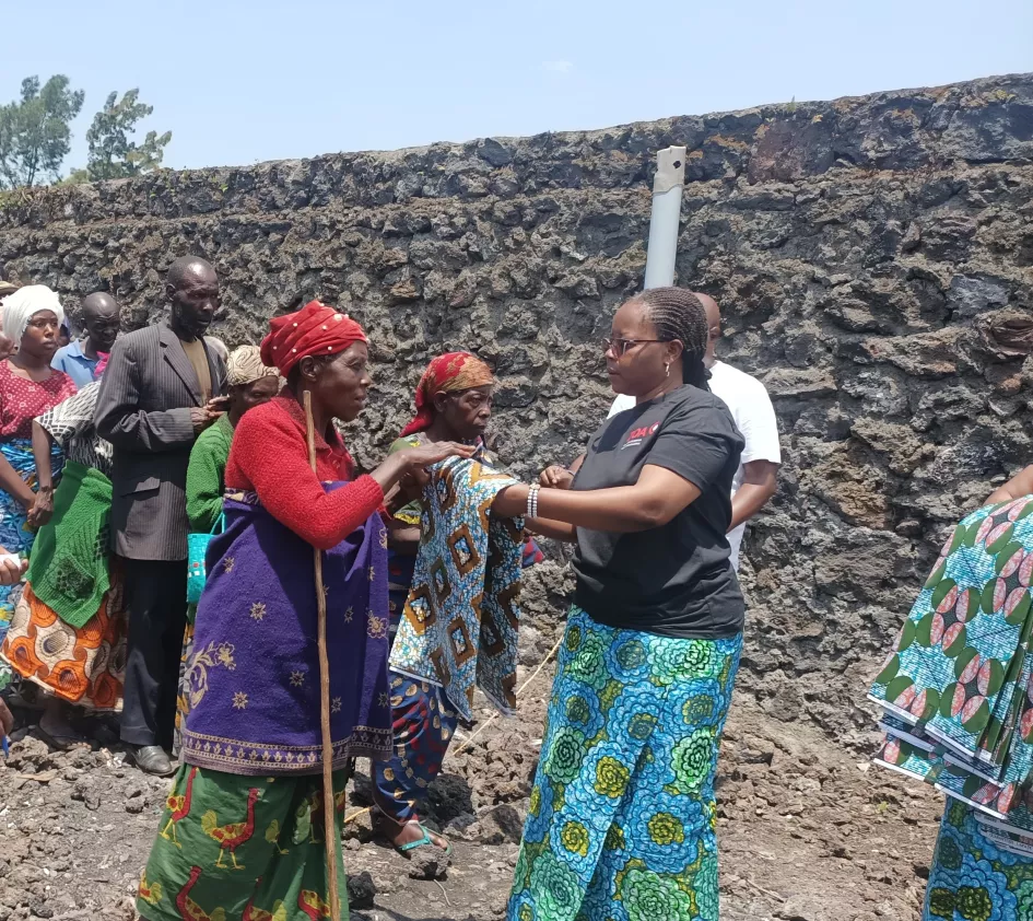 Female ZOA staff member hands out fabric