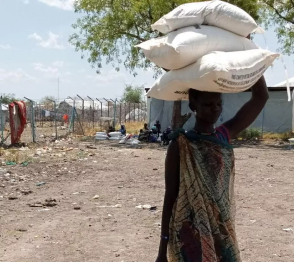Woman in South Sudan carries food on her head