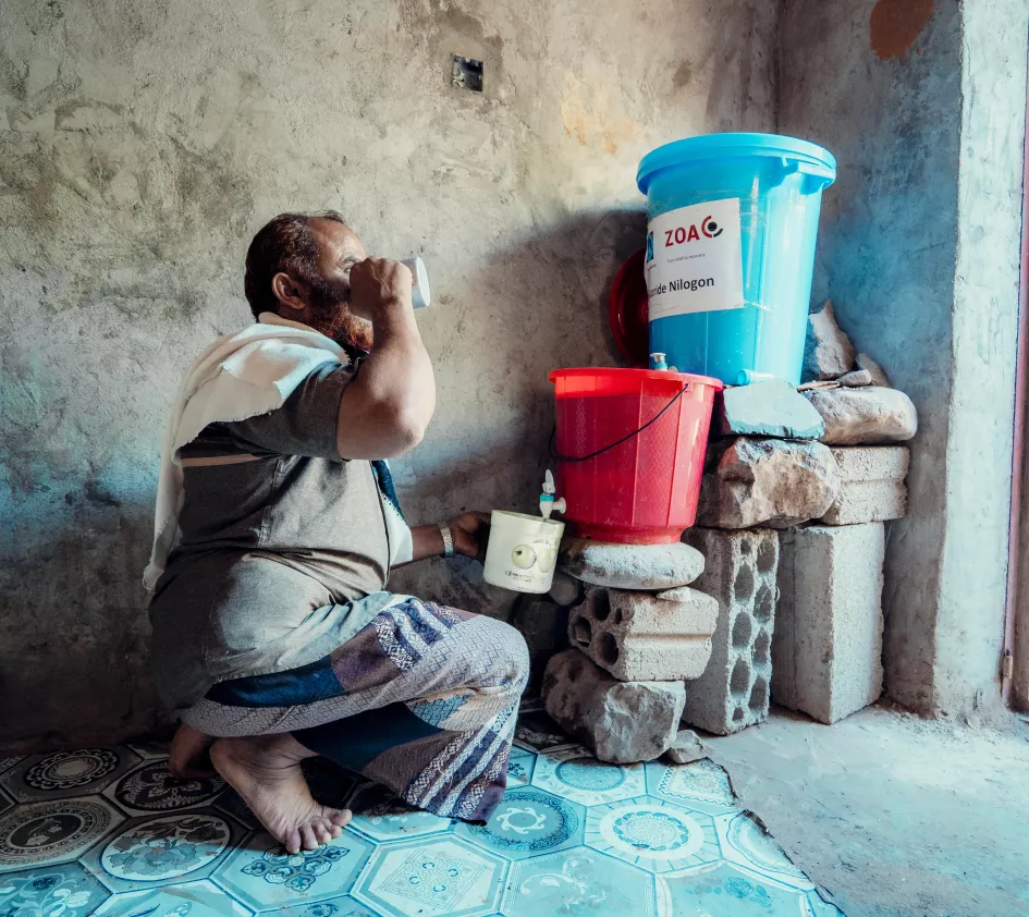 Man in Yemen drinks purified water
