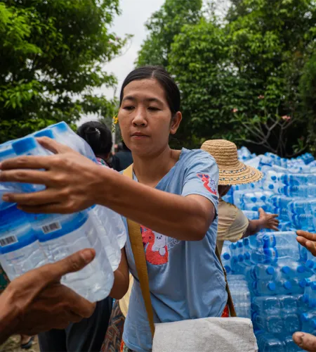 A woman handing out drinking water