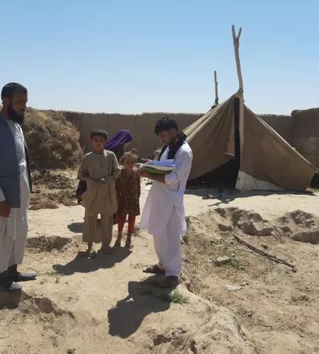 Men in Afghanistan next to a tent