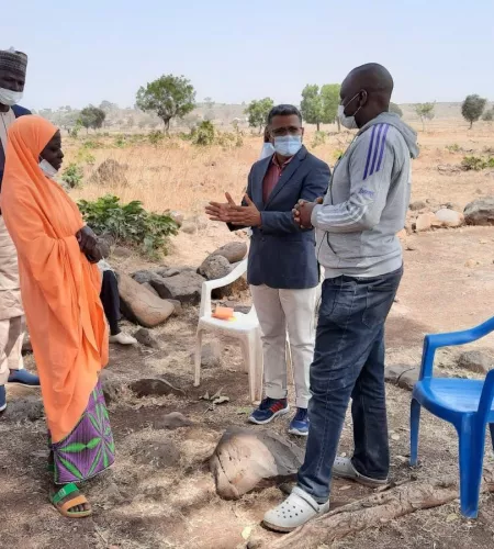 Anthony in the field, talking with people