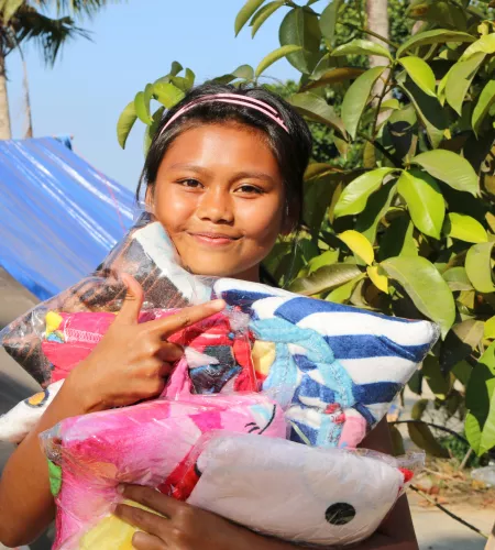 A girl recieves goods at a distribution