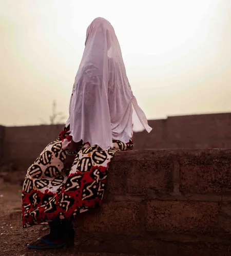 A woman sitting on a wall