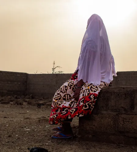 A woman sitting on a wall in Burkina Faso