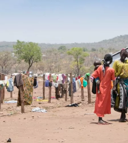 Frauen mit Kind vor ihren Wäscheleinen