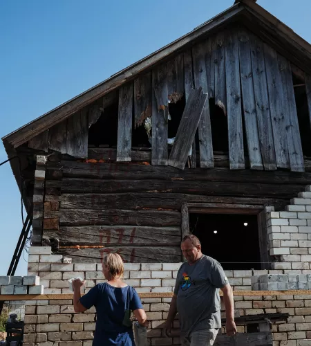 Maryna and her husband working on the shed