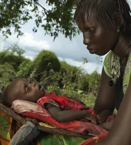 Regina holding her baby