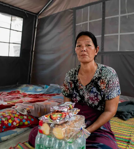 Daw Soe Soe with a food package after the earthquake in Myanmar