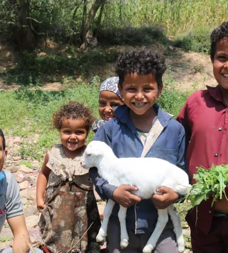 Children in Yemen holding a lamb