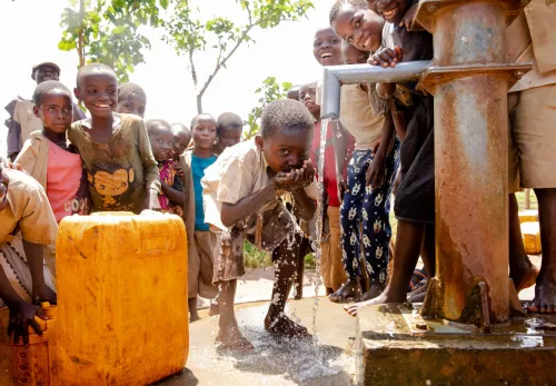 Children drink water from a tap