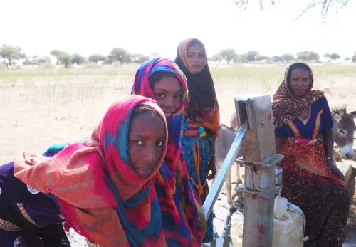 Girl at handpump in SouthDarfur