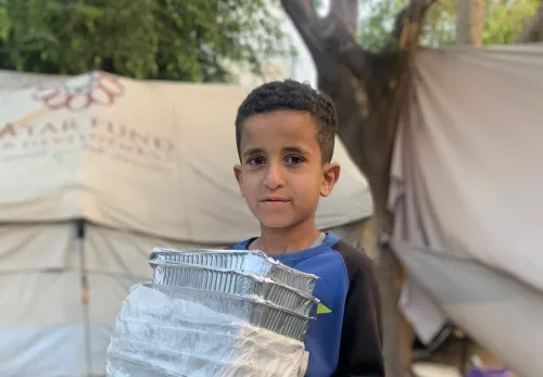 A boy in Gaza receives food