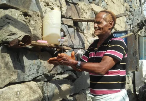 COVID-19: Man washes water on a tap