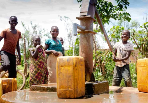 Kids at a water pump