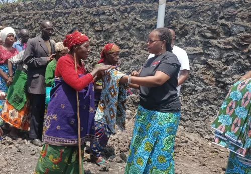 Female ZOA staff member hands out fabric