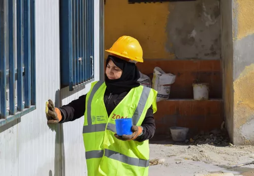 Woman at work in school rehabilitation Syria